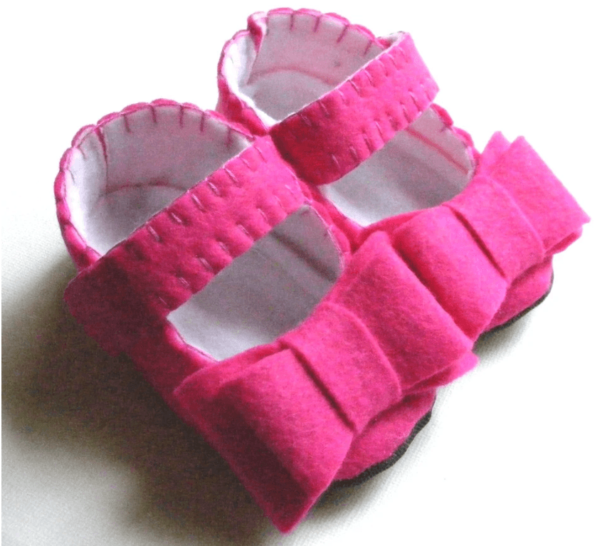 Bright Fuchsia Felt Baby Sandals With White Lining And A Decorative Bow On The Top Strap, Handcrafted And Soft.