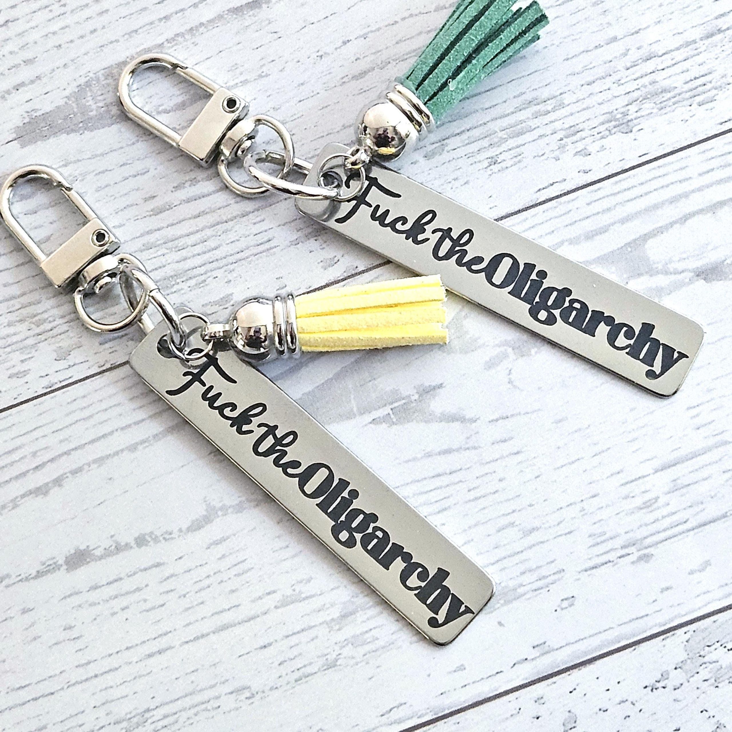 Fuck the Oligarchy Keychain with Tassel – Feminist Stainless Steel Statement Accessory Fuck The Oligarchy Keychain With Tassel – Feminist Stainless Steel Statement Accessory – Keychains – Handmade By Shessocrafty Goods