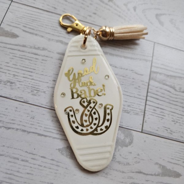 Loud Color. Louder Statements. - ShesSoCrafty Goods Good Luck Babe Keychain: Chic White Gold Design - Cream Tassel β Keychains β Handmade By Shessocrafty Goods