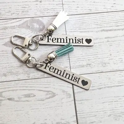 Feminist Keychain – Stainless Steel Statement Accessory with Pink Tassel – Engraved Charm – Keychains – Handmade by ShesSoCrafty Goods